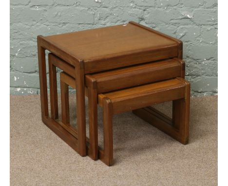 A nest of three vintage teak tables.
