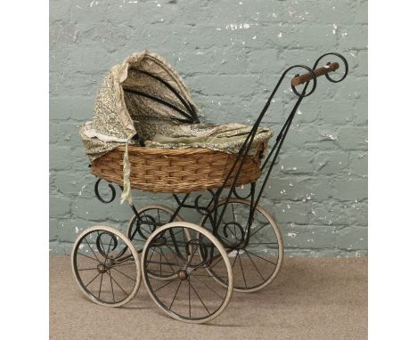 A vintage wicker work dolls pram.