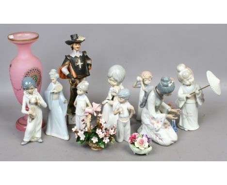 A group of Nao style porcelain figures along with a Aramis the Musketeers, a pink Bohemian glass vase etc.