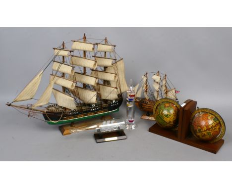 A group of decorative collectables including a glass Galileo thermometer, globe bookends, two models of three mast galleons e