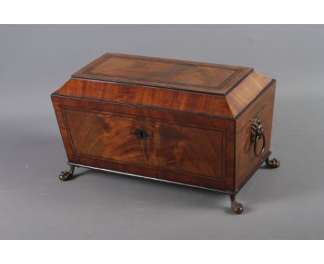 A Georgian mahogany sarcophagus tea caddy with lion ring handles, on claw and ball supports, 13" wide x 6 3/4" deep x 7" high