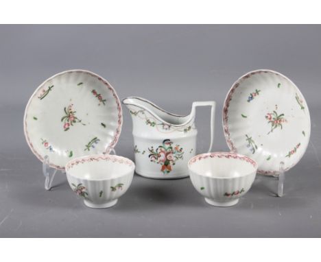 A Newhall (Factory X) cream jug (hair crack) and a pair of similar fluted tea bowls and saucers (fritting to all pieces and o