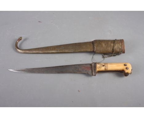 An Indian dagger with steel blade and carved handle with engraved brass and copper scabbard, 18 1/2" long overallCondition:Sm