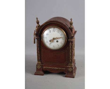 A French? mahogany cased mantel clock with brass decoration, white enamel dial and Arabic numerals, 13" high 
