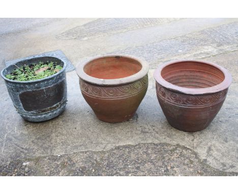 A pair of terracotta plant pots with undulated decoration, 16" dia x 12" high, and a copper planter, 11 1/2" high (cracked) 