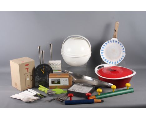 A Danish 1960s cast iron red and white enamelled casserole dish, a stainless steel candlestick, mixed cutlery and other misce