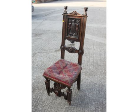 A 19th century Renaissance revival carved walnut side chair with panel back monogrammed "A.D.", bar back and Jacquard tapestr