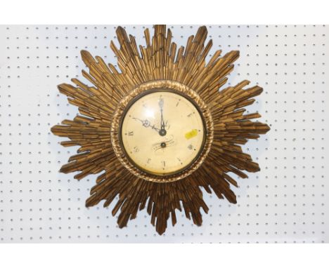 A Cray Pond giltwood sunburst clock with eight-day movement, gilt dial and Roman numerals, 17" diaCondition:No key, not curre