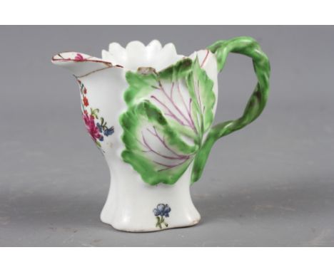 A Longton Hall cream jug with openwork twist handle and leaf relief decoration and enamel floral sprays, 3 1/2" high (restore
