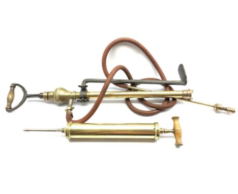 Crescent brass stirrup pump with cast iron bracket, and brass vets pump, (2)