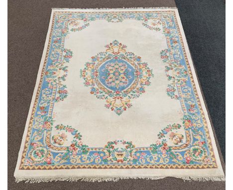 Indian Ivory ground carpet, floral medallion on ivory field, pastel blue boarder, 270cm x 375cm Condition Report & Further De