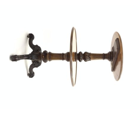 Victorian walnut dumb waiter, having two graduated round tiers with raised moulded edge, turned column with carved oak leaf d