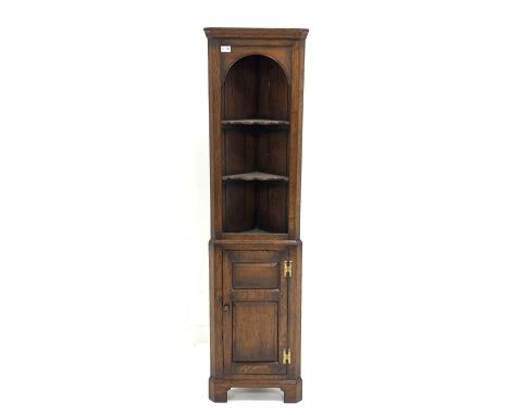 Titchmarsh and Goodwin - Small oak floor standing corner cupboard, projecting cornice over arched recess housing two shaped s