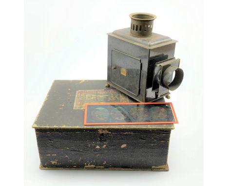 A boxed German made Magic Lantern with brass plaque E.P. in original box, along with 10 coloured slides, W36cm