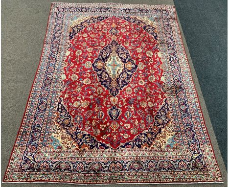 Persian Meshed ground carpet, floral medallion on red field surrounded by foliate, triple guarded border, 278cm x 390cm Condi