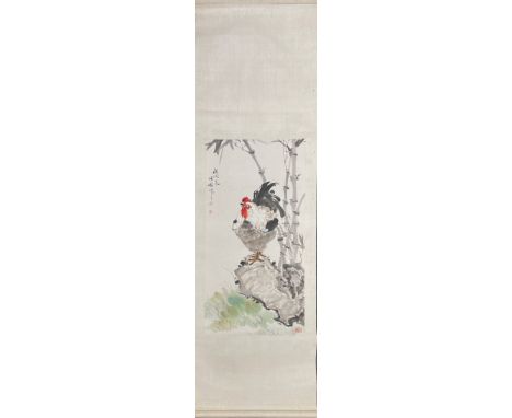 A Chinese watercolour painting mounted on a silk surround of a cockerel on a rock besides stems of bamboo, scroll size 55 x 1