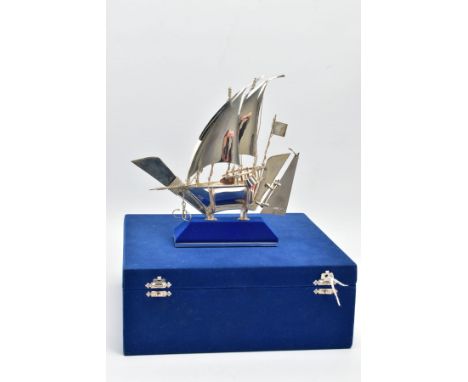 A WHITE METAL BOAT FIGURINE, plain polished sailing boat figurine, detailed with ropes, anchor, bucket stamped Silver 925, to