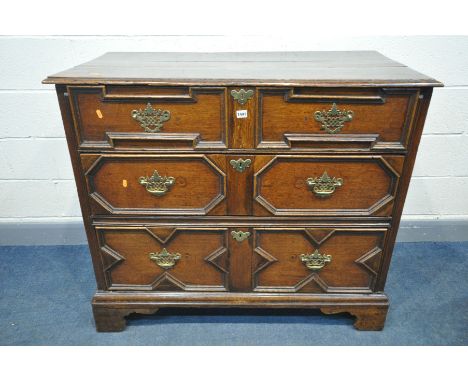 A 17TH CENTURY OAK JACOBEAN LANCASHIRE CHEST, converted from a chest of three drawers, the iron hinged lid over a geometric d