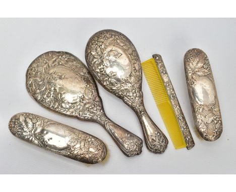 A FIVE PIECE SILVER VANITY SET, comprising of a hair brush, round hand held mirror, two clothes brushes and a silver lined co