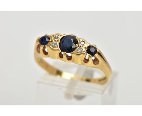 AN 18CT GOLD SAPPHIRE AND DIAMOND RING, designed with three graduated blue sapphires, interspaced with four single cut diamon