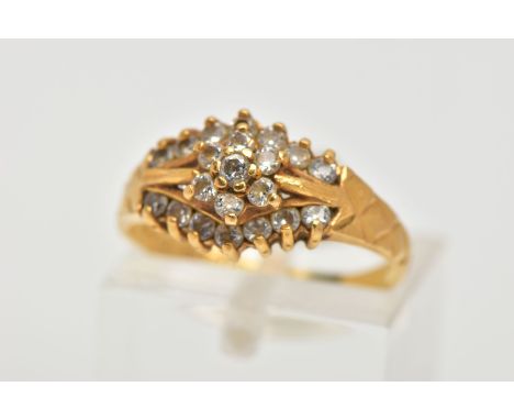 A 22CT GOLD CUBIC ZIRCONIA DRESS RING, set with a flower cluster of colourless cubic zirconia between two further rows, textu