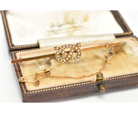 AN EARLY 20TH CENTURY, 15CT GOLD STAFFORDSHIRE KNOT BROOCH,  the knot set with seed pearls, stamped 15c, mounted on a plain p