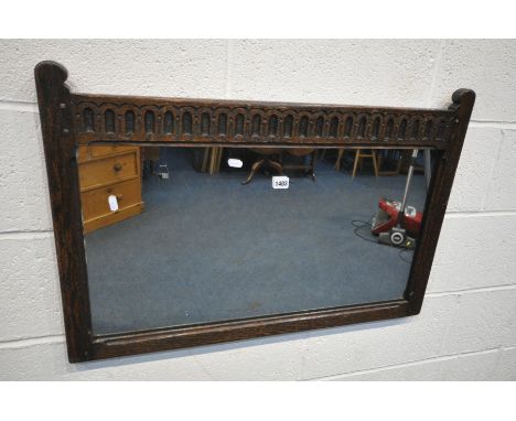 A MID CENTURY OAK WALL MIRROR, with carved top rail, 84cm x 57cm