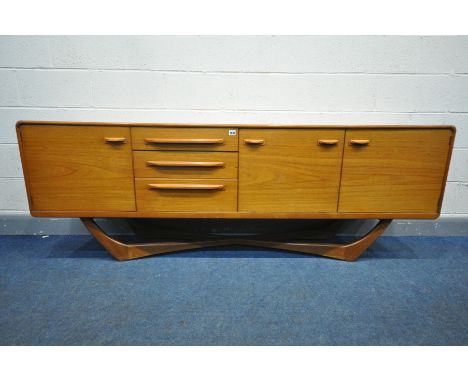 A 1960'S BEITHCRAFT TEAK SIDEBOARD, organic range, fitted with two cupboard doors that's flanking a fall front cupboard door 