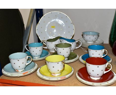 A TWENTY SEVEN PIECE SUSIE COOPER TEA SET, in Gold Star pattern, each cup having a different solid coloured interior and matc