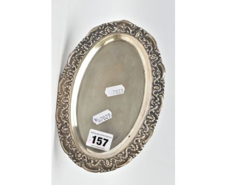 AN OVAL WHITE METAL TRAY, embossed foliate rim, engraved to the reverse of the base 'Presented to Captain &amp; Mrs T. K. Wil
