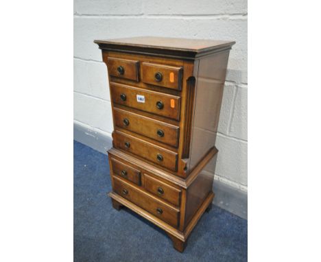 A SMALL REPRODUX WALNUT EIGHT DRAWER CHEST ON CHEST, on bracket feet, width 42cm x depth 30cm x height 77cm (condition:-top s