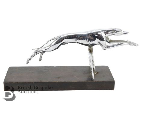 An English Art Deco accessory mascot of a racing greyhound vaulting a gate, well detailed features. Measures approx. 11 x 25c