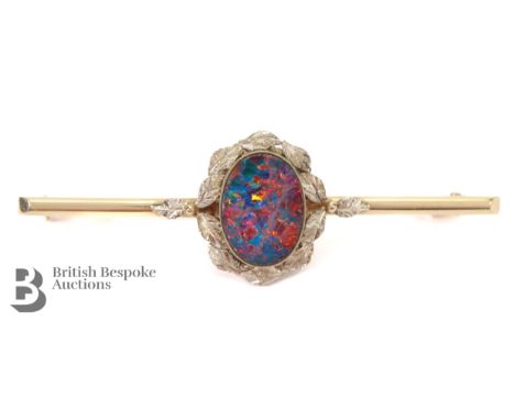 10ct gold bar brooch, set with an oval fire opal doublet, 12 x 8mm in a laurel-leaf setting, approx 53 mm in length, approx 3