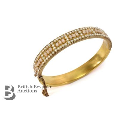Edwardian 14ct/15ct tested yellow gold, seed pearl and coral bangle. The bangles internal measurement is 58 x 50 mm, 17.4 gms