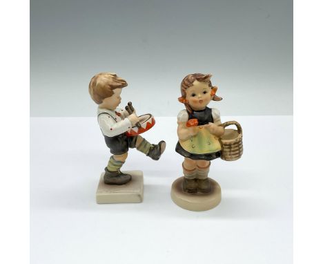 Hand made and hand painted porcelain figures; one of a boy drumming and the other a young girl with a basket and flower. Goeb