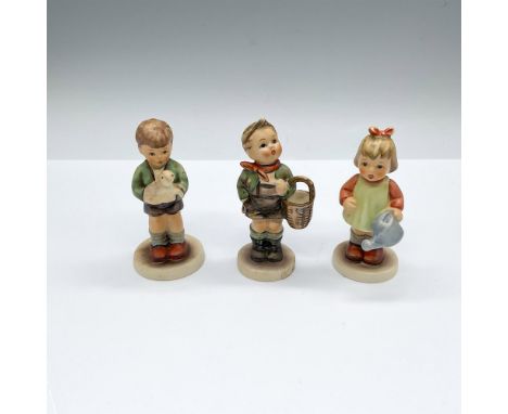 Hand painted and hand made porcelain Hummel figures; one of a boy holding a lamb, a boy holding a basket, and a girl with a w
