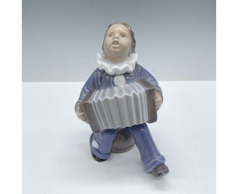 Glazed finish. Features a boy signing and playing the instrument, dressed in pale blue clothes. Royal Copenhagen backstamp. I