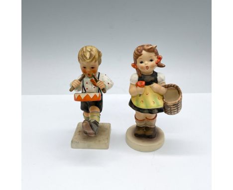Hand made and hand painted porcelain figures; one of a boy drumming and the other a young girl with a basket and flower. Goeb