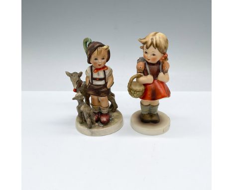 Hand painted and hand made Hummel figures; one of a young boy with goats, and the other of a young girl ready for school. Goe