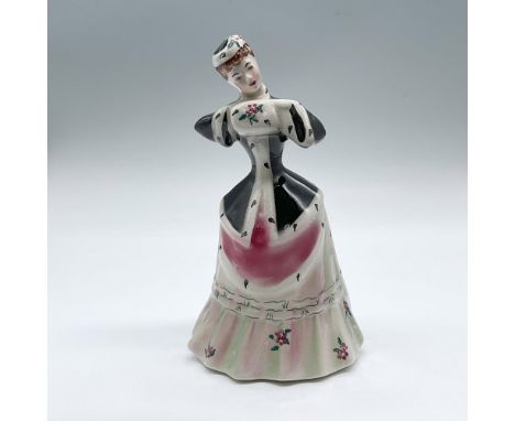 Hand made and hand painted fine china figure of a woman in a black winter coat and pink and green flower dress. Title and art