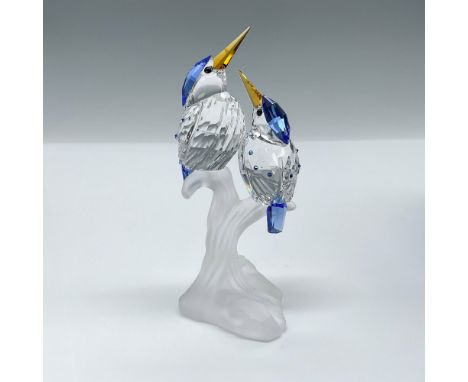 Two clear crystals birds perched on a frosted branch. Sapphire crystal tails, hoods, and wings, and topaz crystal beaks. Swar