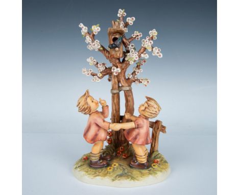 Hand made and hand painted porcelain figure two kids beside a white blossomed tree, admiring a bird perched on a birdhouse. G