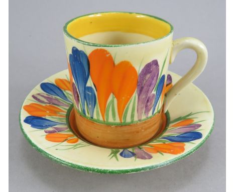 An early twentieth century Art Deco Newport Pottery Clarice Cliff Crocus pattern coffee can and saucer, c. 1930. It is hand-p