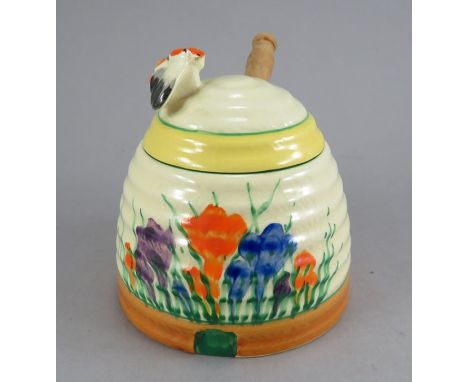 An early twentieth century Art Deco Newport Pottery Clarice Cliff Crocus pattern lidded honey pot and spoon, c. 1930. It is h