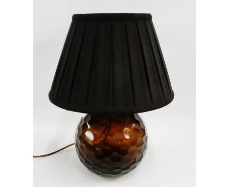 A smoked glass table lamp base of globular form, complete with a black pleated shade