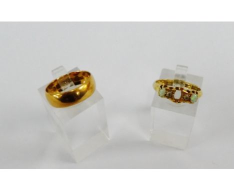 An 18 carat gold wedding band and a 18 carat gold and opal ring (one stone lacking) (2) 