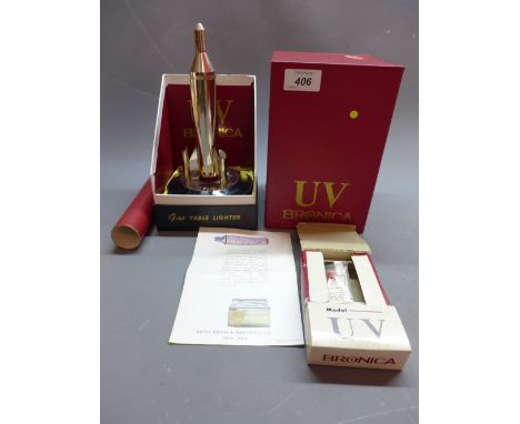 A vintage model UV Bronica table lighter in the form of a rocket in original box 