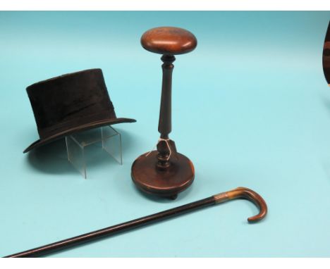 A top hat, by Tress & Co., London, on mahogany and elm hat stand, 15in. and a silver-mounted walking stick with horn handle