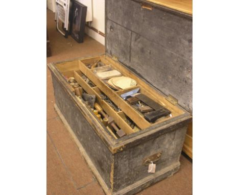 A collection of carpentry tools, contained within painted pine tool trunk