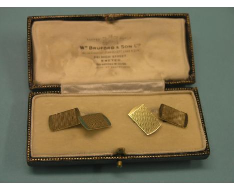 A pair of 9ct. gold cuff-links, engine-turned, 3.9 grams total, in original case 